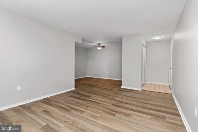 a view of an empty room with wooden floor