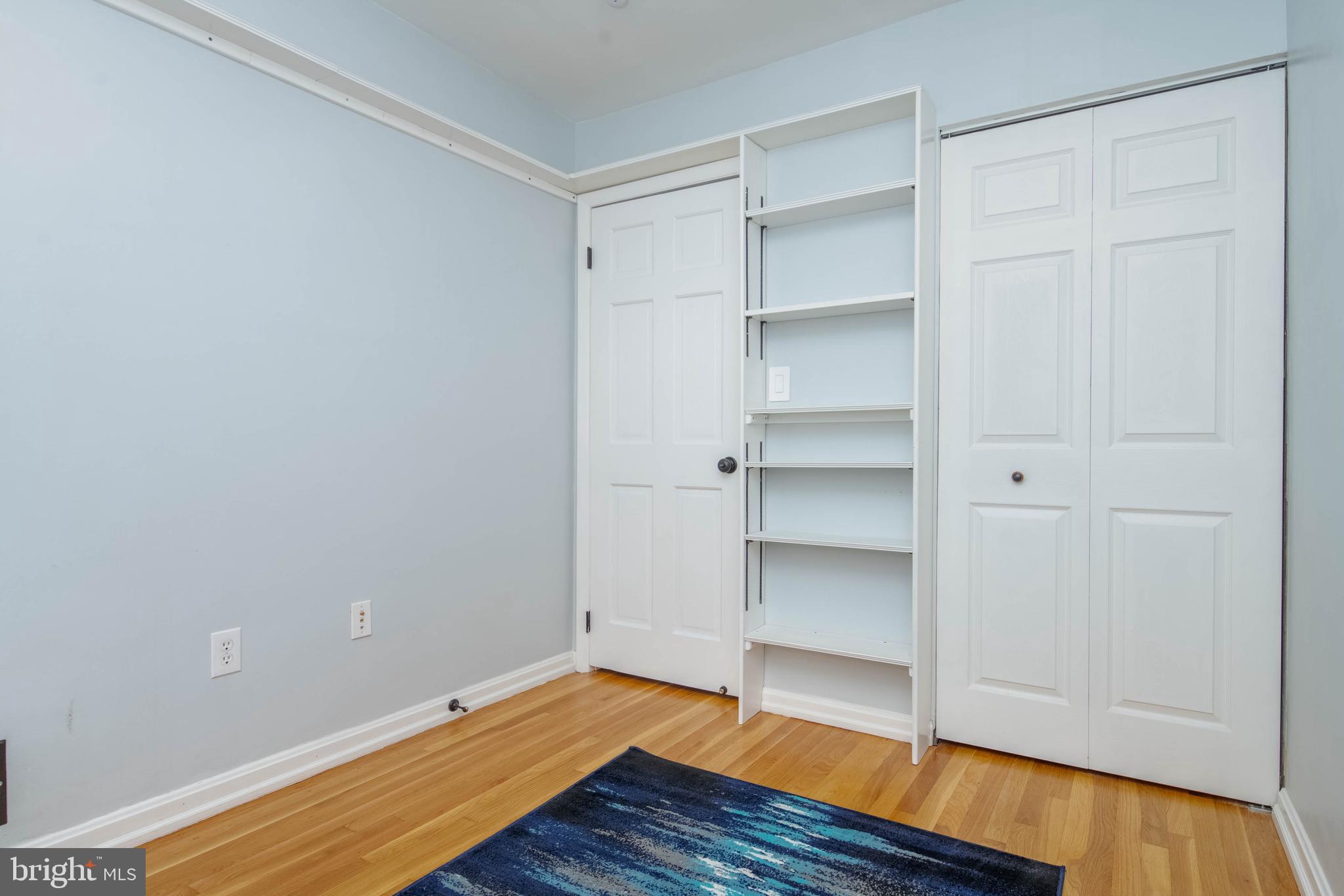 8528 Kings Ridge Road Baltimore, MD 21234 - Photo 25 of 45 a view of an empty room with a closet and wooden floor