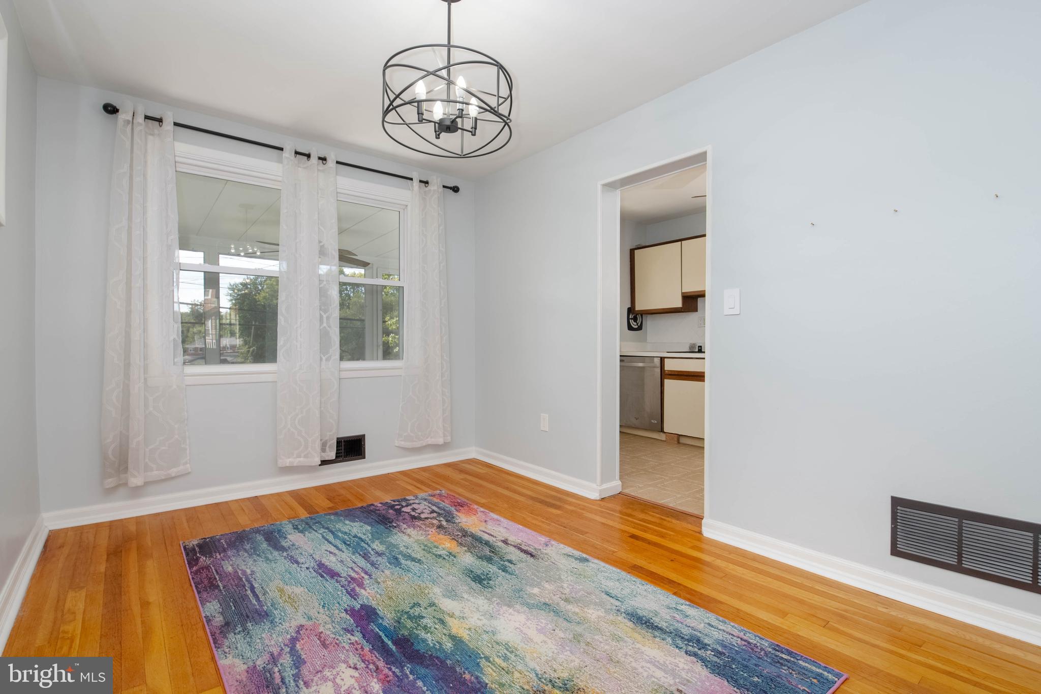 8528 Kings Ridge Road Baltimore, MD 21234 - Photo 10 of 45 a view of an empty room with wooden floor and a window