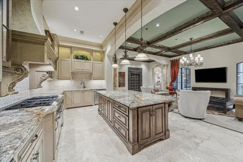 a kitchen with stainless steel appliances granite countertop a stove and a sink
