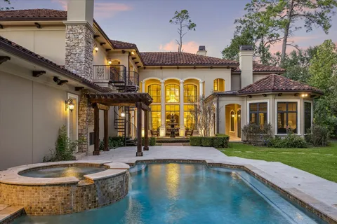 a view of a white building with a swimming pool