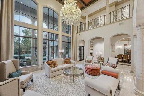 a living room with patio furniture and a large window