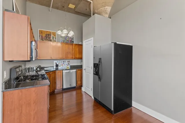 a kitchen with granite countertop a refrigerator and a stove