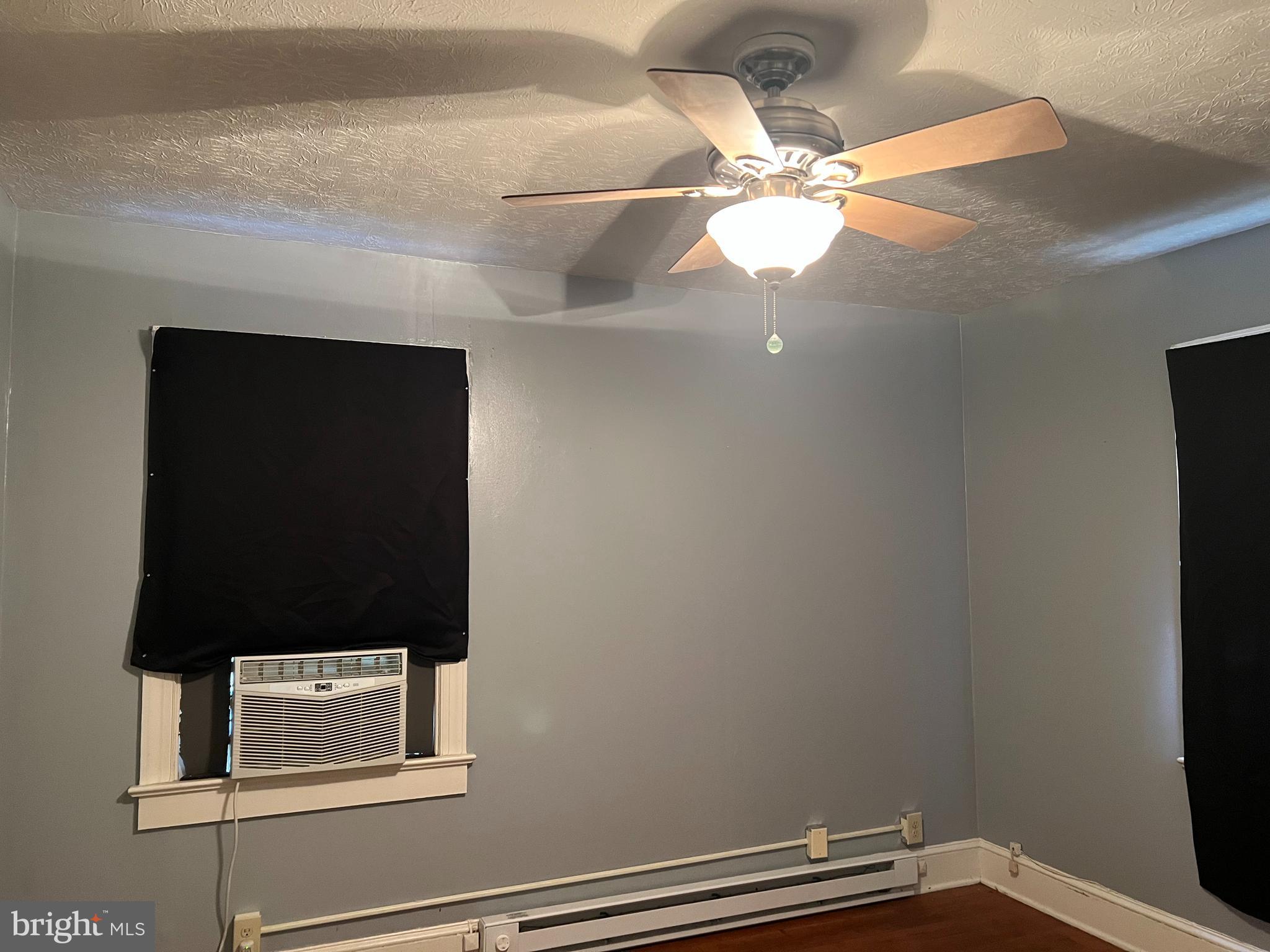 110 South Charles Street, Unit 8 Charles Town, WV 25414 - Photo 12 of 14 a room with a lamp and a fan