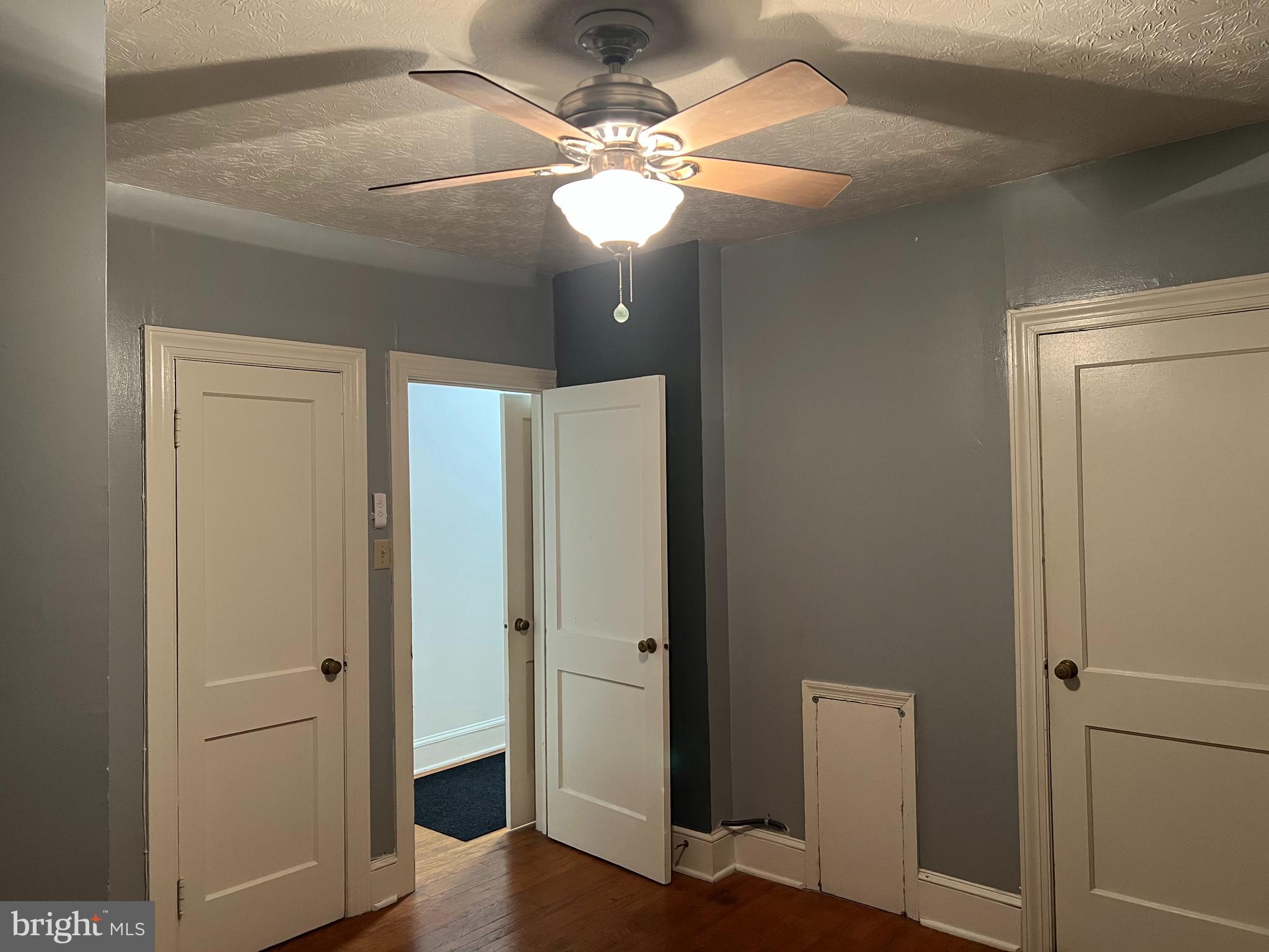 110 South Charles Street, Unit 8 Charles Town, WV 25414 - Photo 14 of 14 a view of a hallway with a chandelier fan and wooden floor