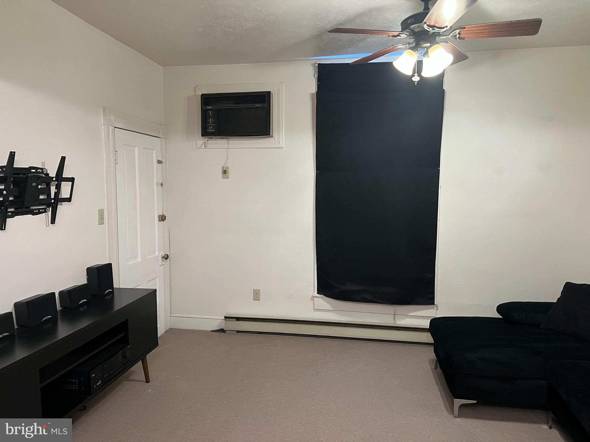 110 South Charles Street, Unit 8 Charles Town, WV 25414 - Photo 2 of 14 a living room with furniture and a flat screen tv
