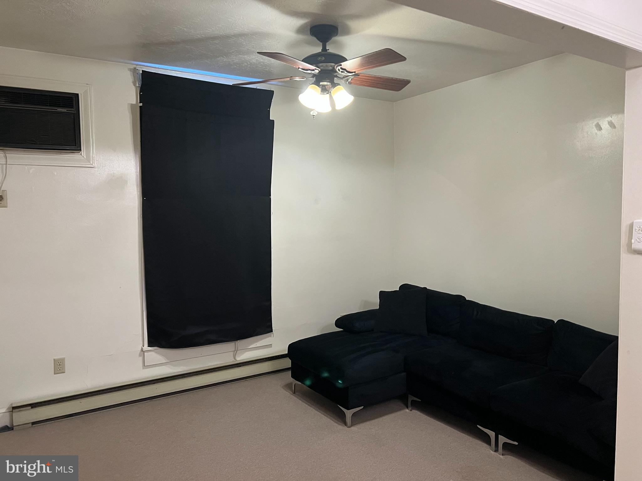 110 South Charles Street, Unit 8 Charles Town, WV 25414 - Photo 3 of 14 a living room with furniture and a ceiling fan