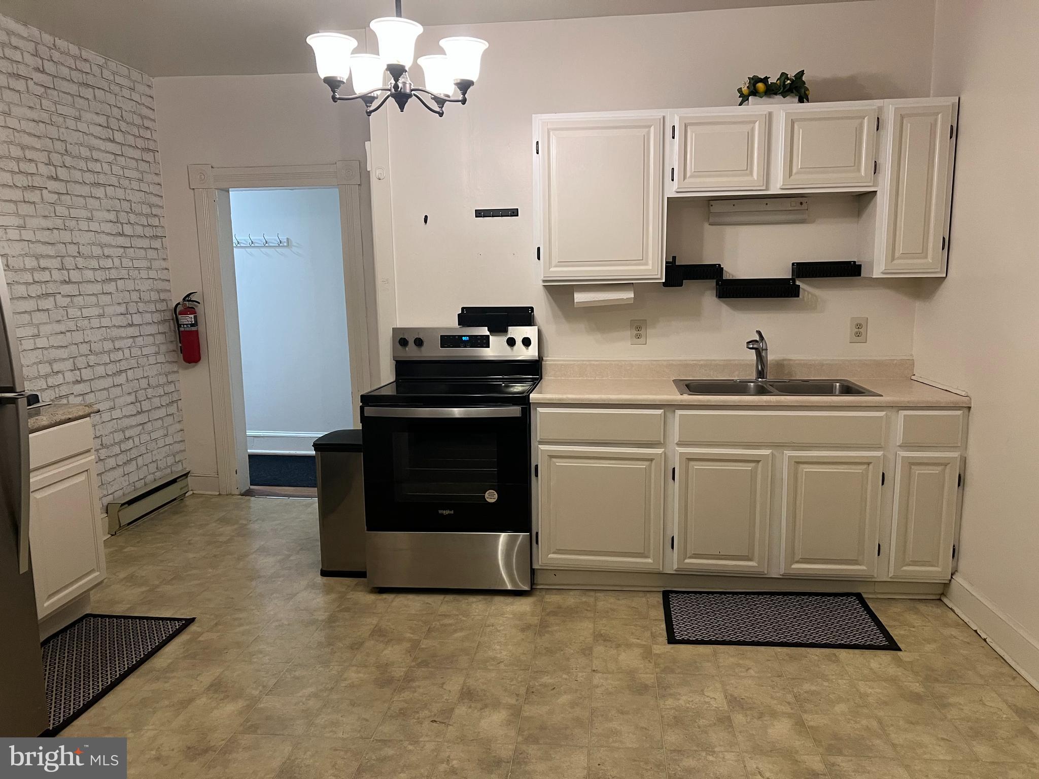 110 South Charles Street, Unit 8 Charles Town, WV 25414 - Photo 4 of 14 a kitchen with stainless steel appliances a stove a sink and a refrigerator