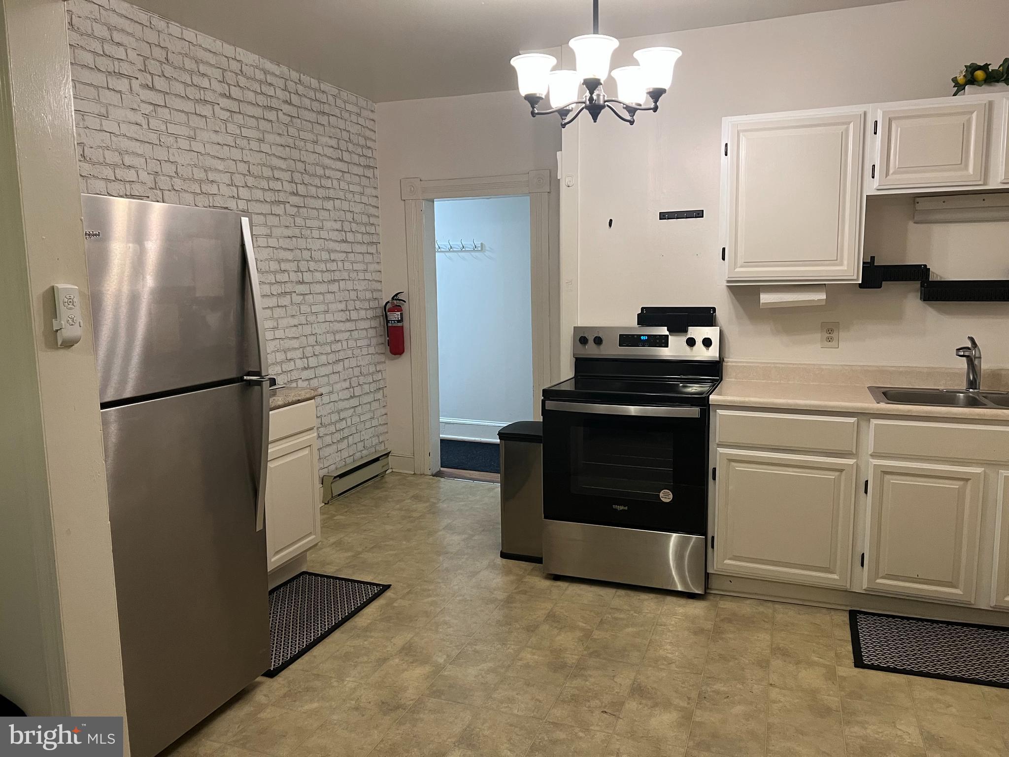 110 South Charles Street, Unit 8 Charles Town, WV 25414 - Photo 5 of 14 a kitchen with a refrigerator and white cabinets