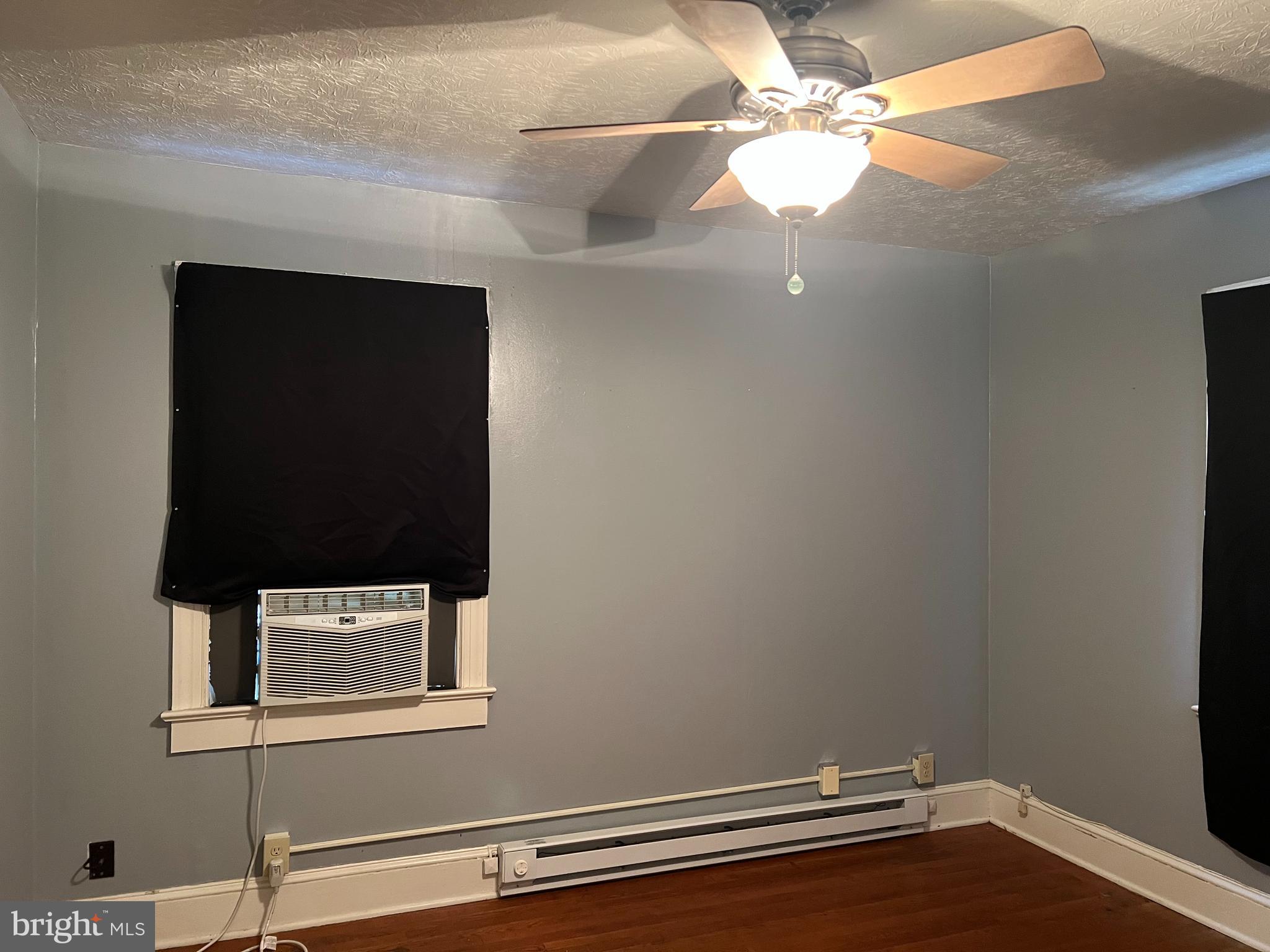 110 South Charles Street, Unit 8 Charles Town, WV 25414 - Photo 7 of 14 a view of a small space with wooden floor and a fan