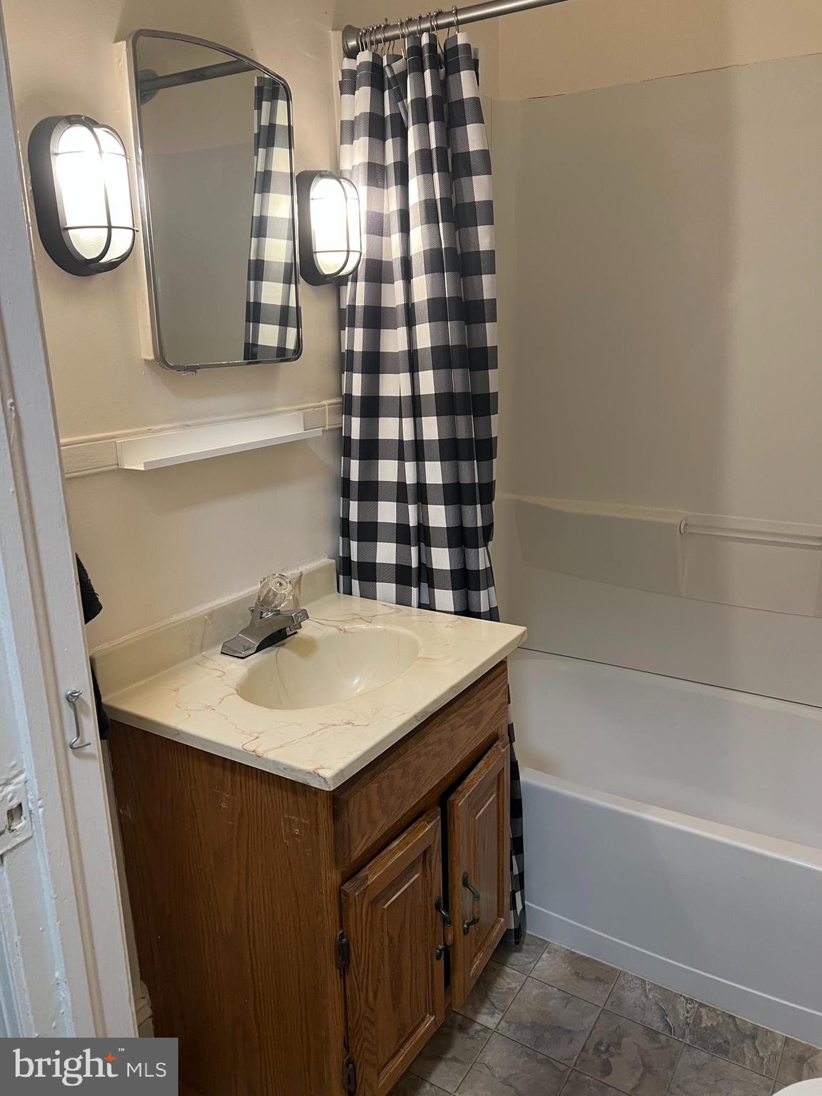 110 South Charles Street, Unit 8 Charles Town, WV 25414 - Photo 8 of 14 a bathroom with a sink and a mirror