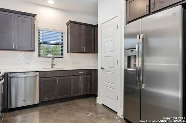 a kitchen with a refrigerator and a sink