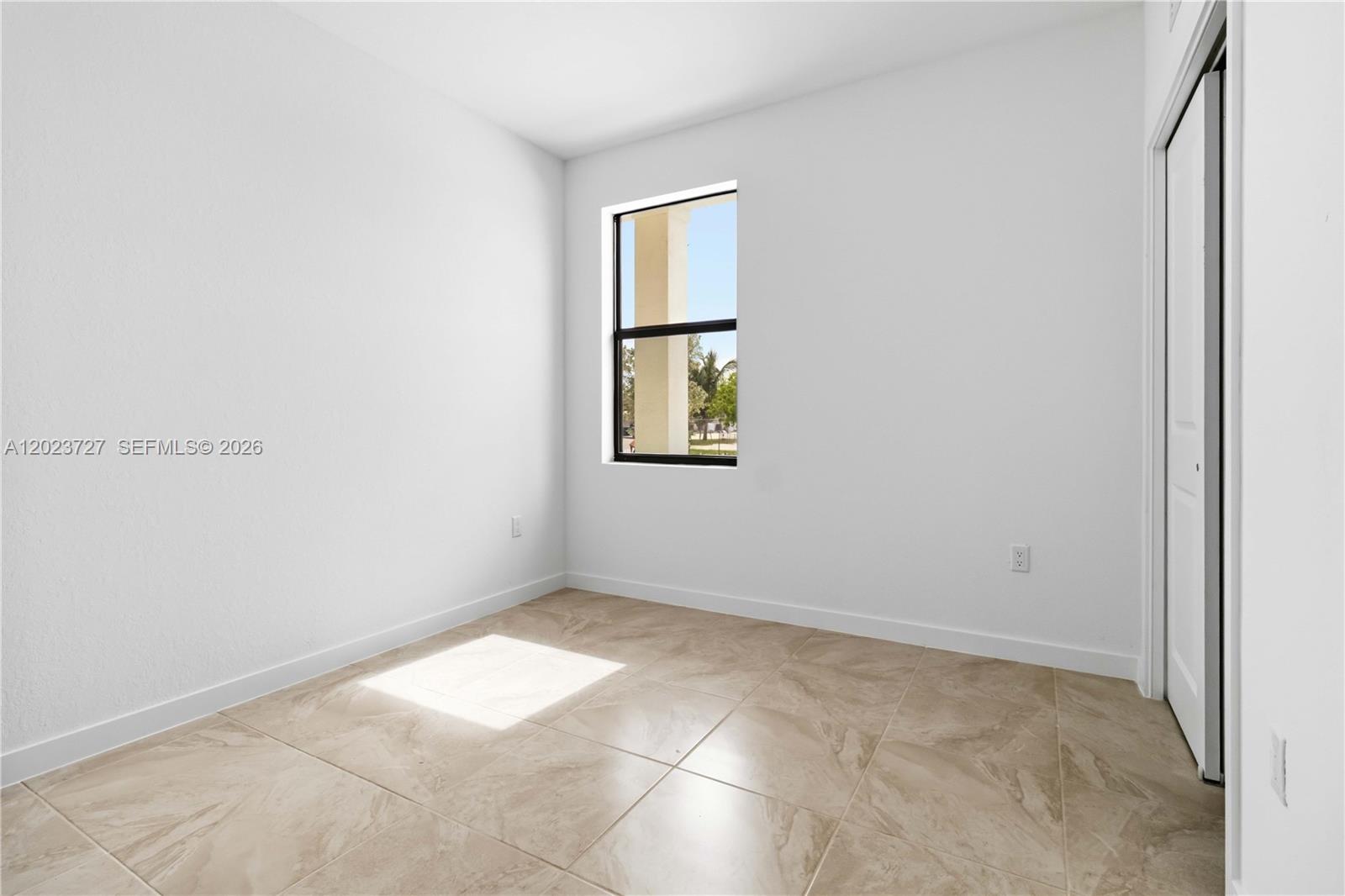 22348 Southwest 115th Court, Unit 22348 Miami, FL 33170 - Photo 31 of 37 an empty room with windows and closet