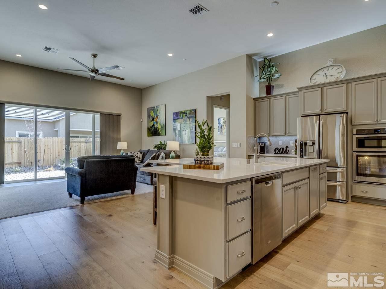 9440 Stony Hill Road Reno, NV 89521 - Photo 5 of 24 a kitchen with stainless steel appliances granite countertop a sink and a refrigerator