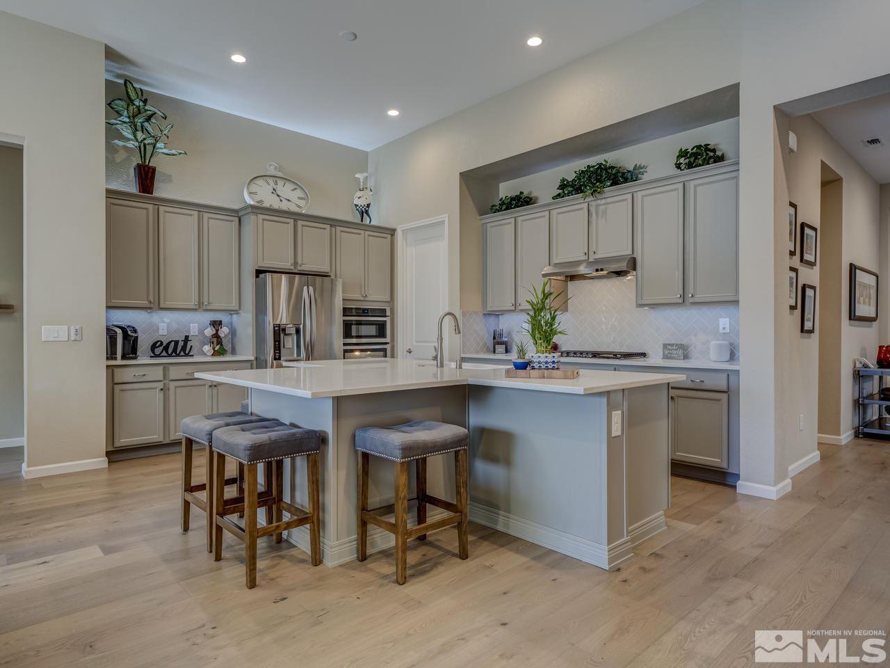 9440 Stony Hill Road Reno, NV 89521 - Photo 8 of 24 a kitchen with white cabinets and chairs