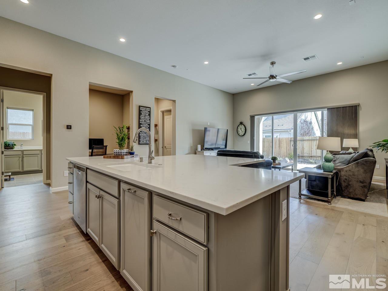 9440 Stony Hill Road Reno, NV 89521 - Photo 9 of 24 a kitchen with kitchen island a sink appliances and a large window