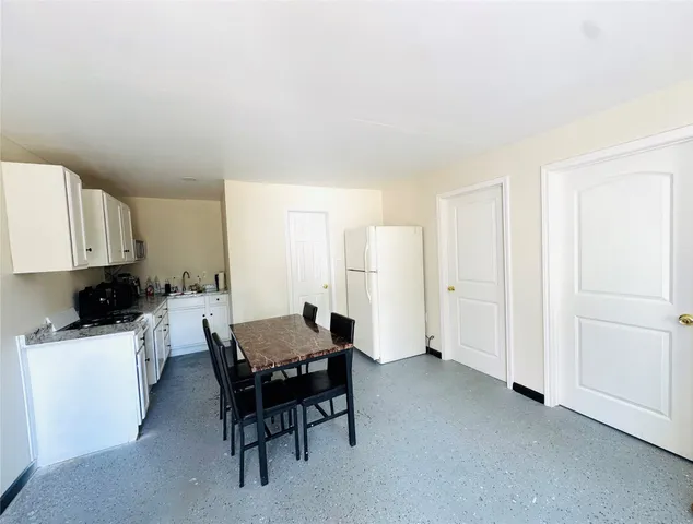 a view of a dining room with furniture and a window