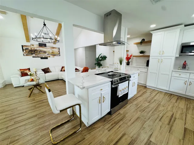 a kitchen with stainless steel appliances a refrigerator sink and stove