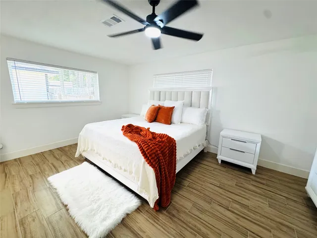 a bedroom with a bed and a ceiling fan