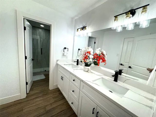 a bedroom with a bed and a night stand