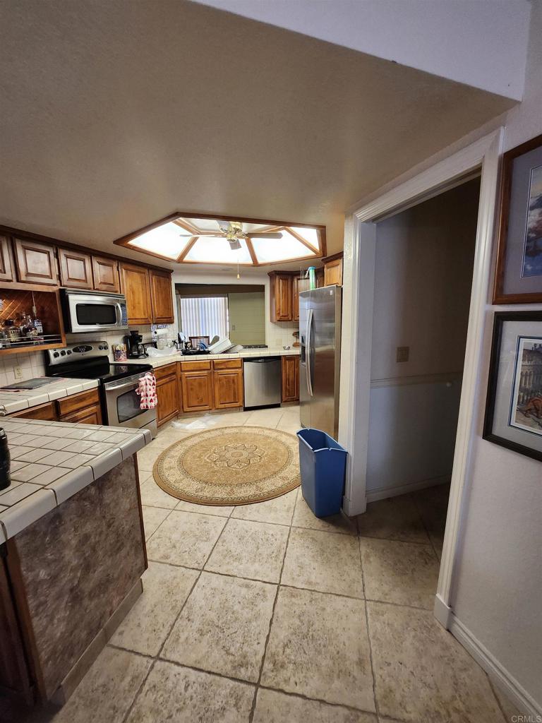 1481 El Nido Drive Fallbrook, CA 92028 - Photo 3 of 8 a kitchen with stainless steel appliances granite countertop a sink and cabinets