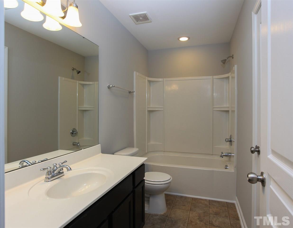 1025 Ileagnes Road Raleigh, NC 27603 - Photo 16 of 25 a bathroom with a sink a toilet and shower