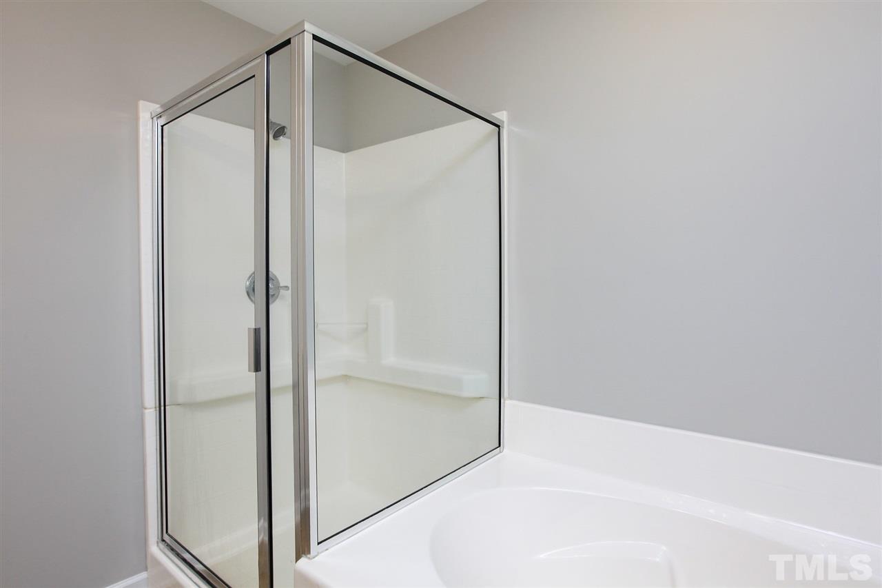 1025 Ileagnes Road Raleigh, NC 27603 - Photo 20 of 25 a bathroom with a glass shower door