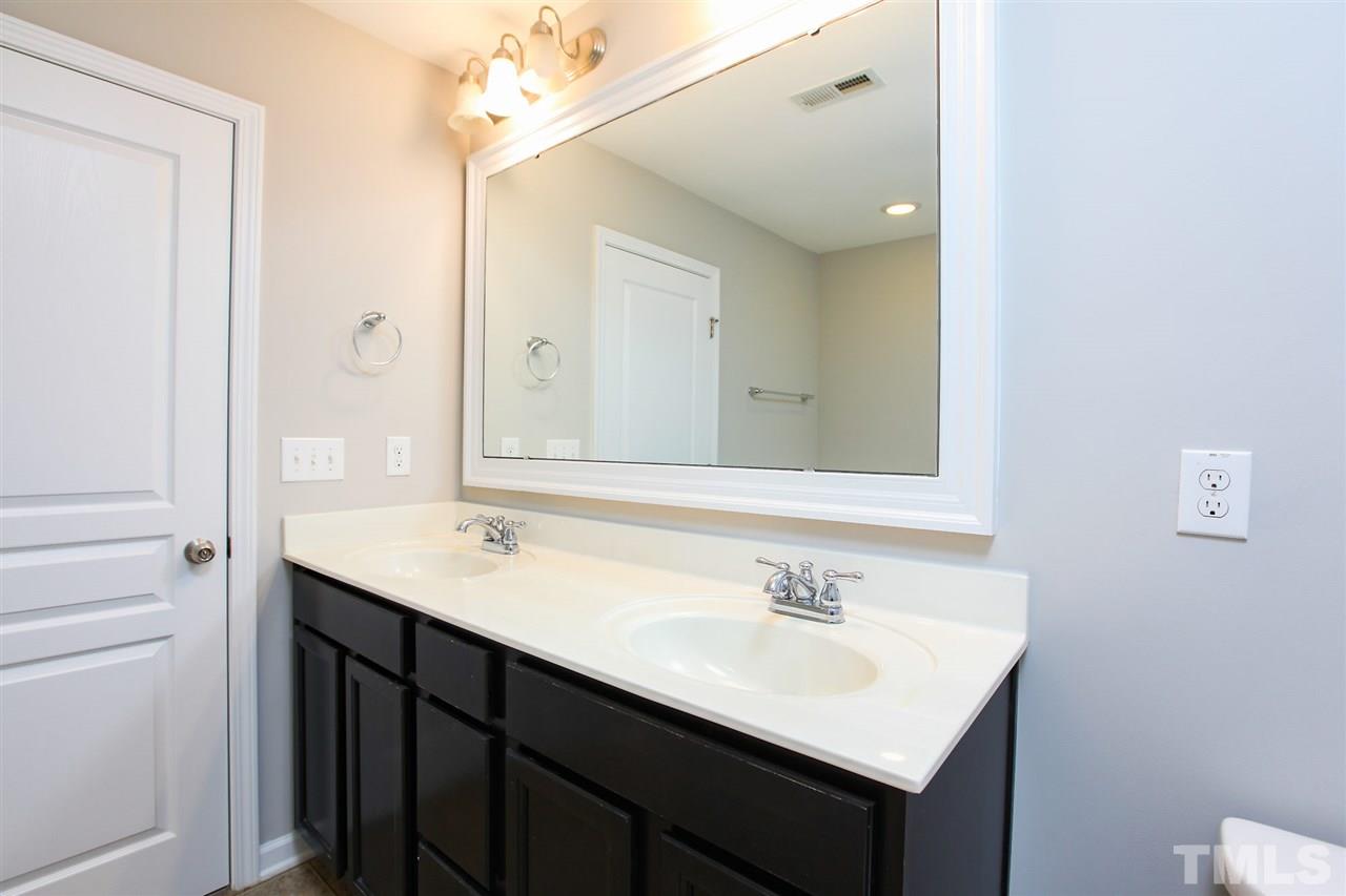 1025 Ileagnes Road Raleigh, NC 27603 - Photo 3 of 25 a bathroom with a sink vanity and a mirror
