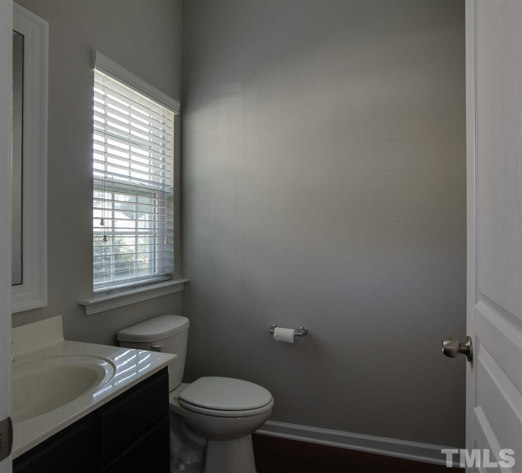 1025 Ileagnes Road Raleigh, NC 27603 - Photo 4 of 25 a bathroom with a sink toilet and window