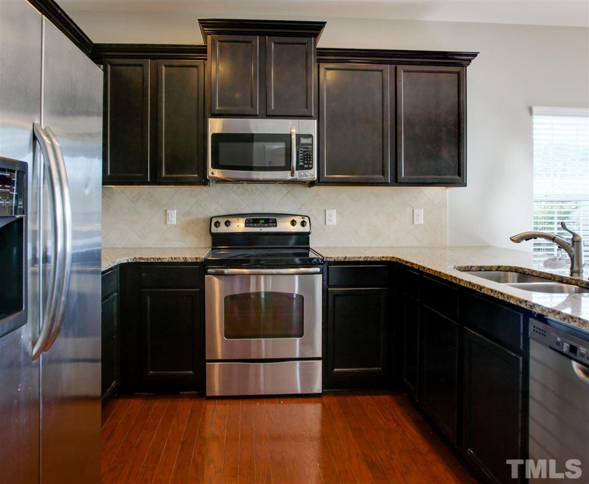 1025 Ileagnes Road Raleigh, NC 27603 - Photo 8 of 25 a kitchen with a refrigerator and a sink