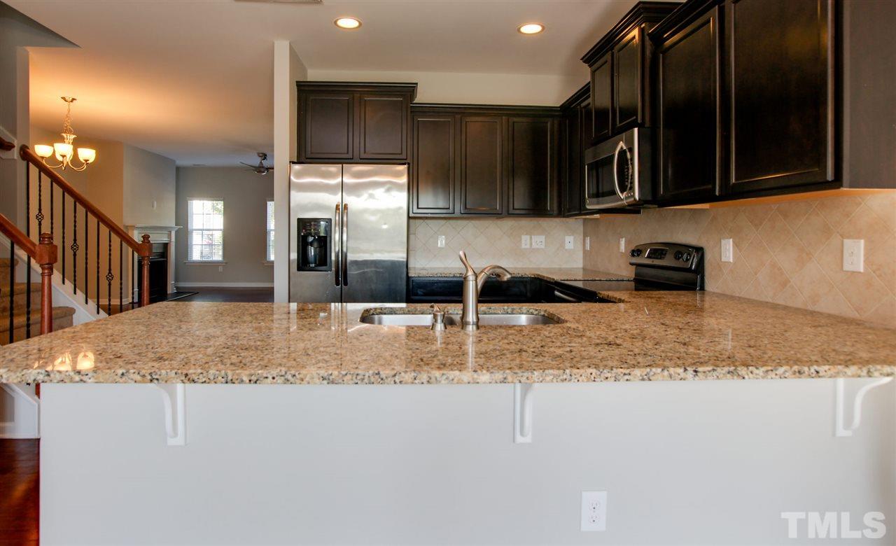 1025 Ileagnes Road Raleigh, NC 27603 - Photo 10 of 25 a kitchen with stainless steel appliances granite countertop a sink a stove and a microwave oven