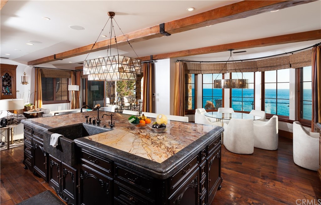 177 Shorecliff Road Corona del Mar, CA 92625 - Photo 12 of 48 a view of a dining room with furniture wooden floor and a chandelier