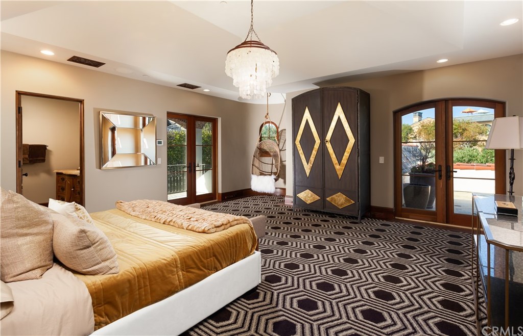 177 Shorecliff Road Corona del Mar, CA 92625 - Photo 44 of 48 a bedroom with a large bed and a chandelier