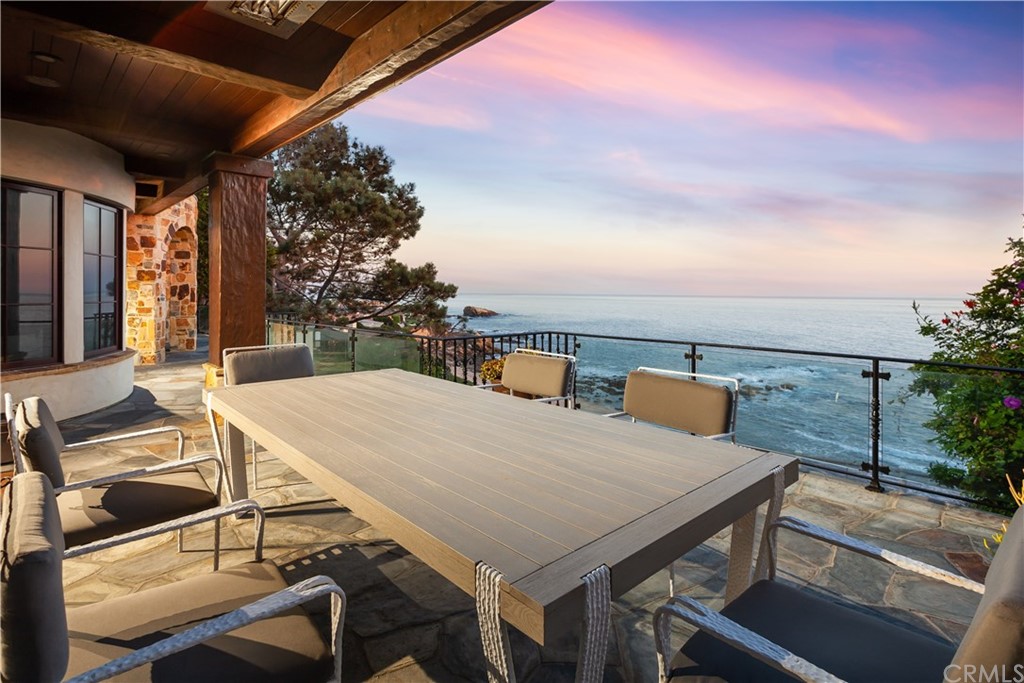 177 Shorecliff Road Corona del Mar, CA 92625 - Photo 45 of 48 a view of a patio with table and chairs with wooden floor and fence