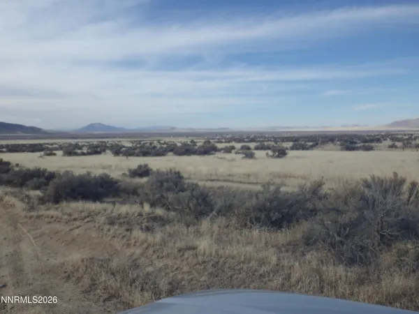 a view of a lake with houses in back