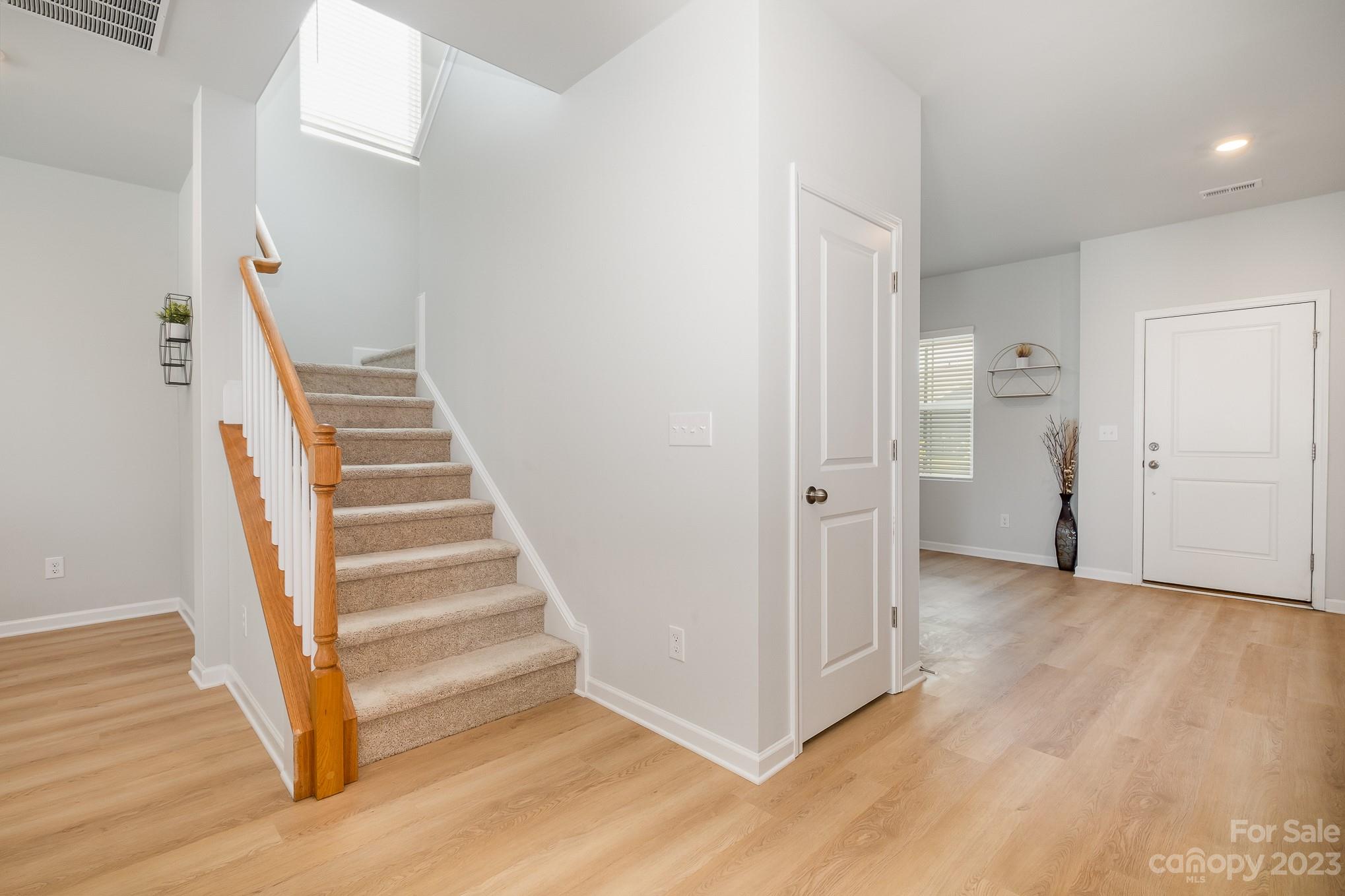 7015 Messina Road Indian Land, SC 29707 - Photo 17 of 42 a view of a hallway with wooden floor and entryway