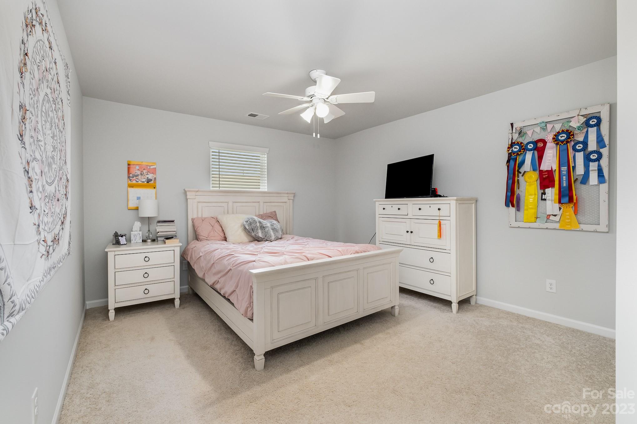 7015 Messina Road Indian Land, SC 29707 - Photo 33 of 42 a spacious bedroom with a bed and a flat screen tv