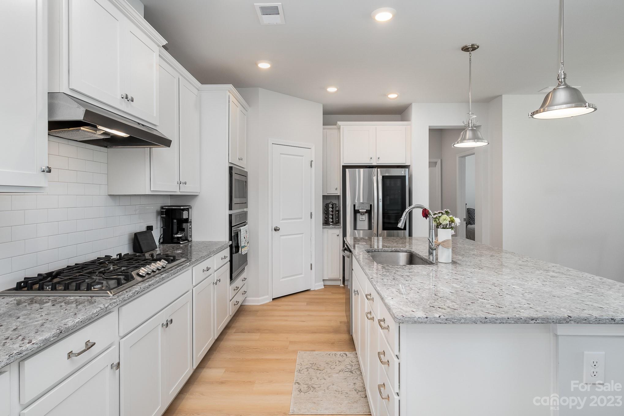 7015 Messina Road Indian Land, SC 29707 - Photo 7 of 42 a kitchen with granite countertop kitchen island a sink stainless steel appliances and cabinets