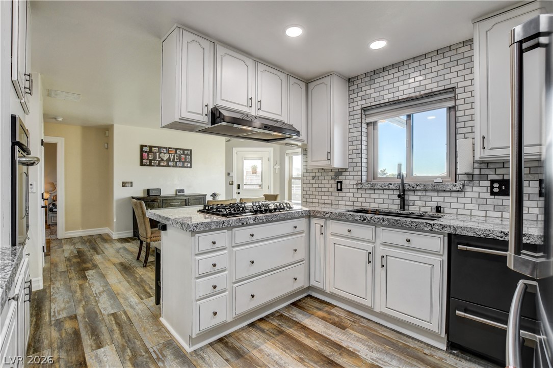 6460 Racel Street Las Vegas, NV 89131 - Photo 38 of 59 Granite countertops and subway tile backsplashes accent this updated kitchen space.