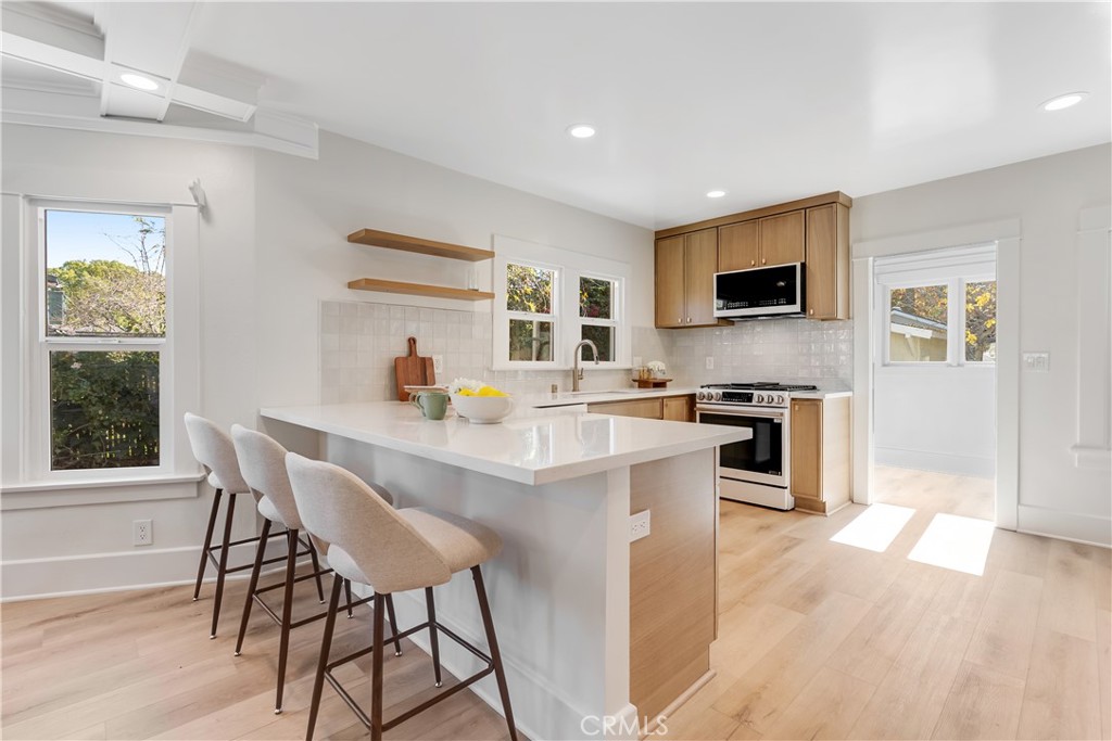 400 Flower Street Pasadena, CA 91104 - Photo 12 of 37 a kitchen with a dining table chairs and refrigerator