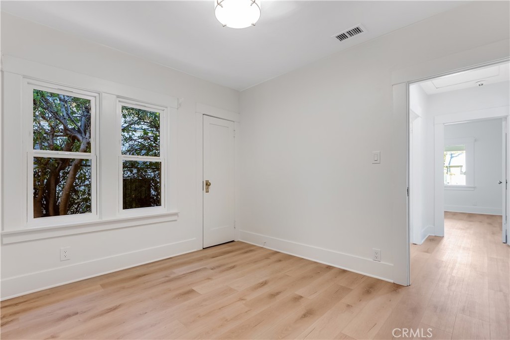 400 Flower Street Pasadena, CA 91104 - Photo 26 of 37 a view of an empty room with wooden floor and a window