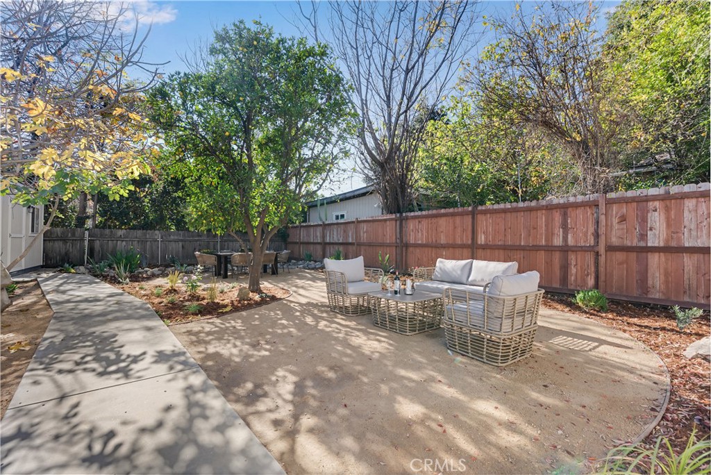 400 Flower Street Pasadena, CA 91104 - Photo 34 of 37 a view of backyard with table and chairs and wooden fence