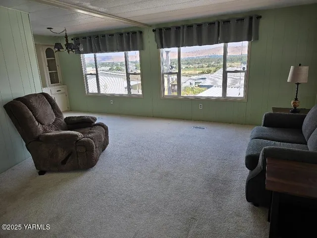 a view of a livingroom with an empty space and a window