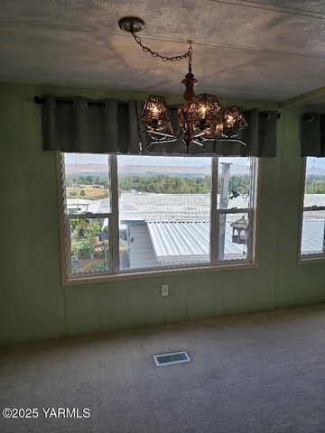 a large kitchen with cabinets wooden floor and stainless steel appliances