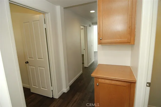 a view of walk in closet with wooden floor