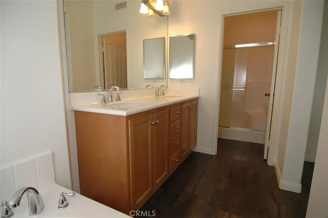 a bathroom with a sink a mirror and a shower