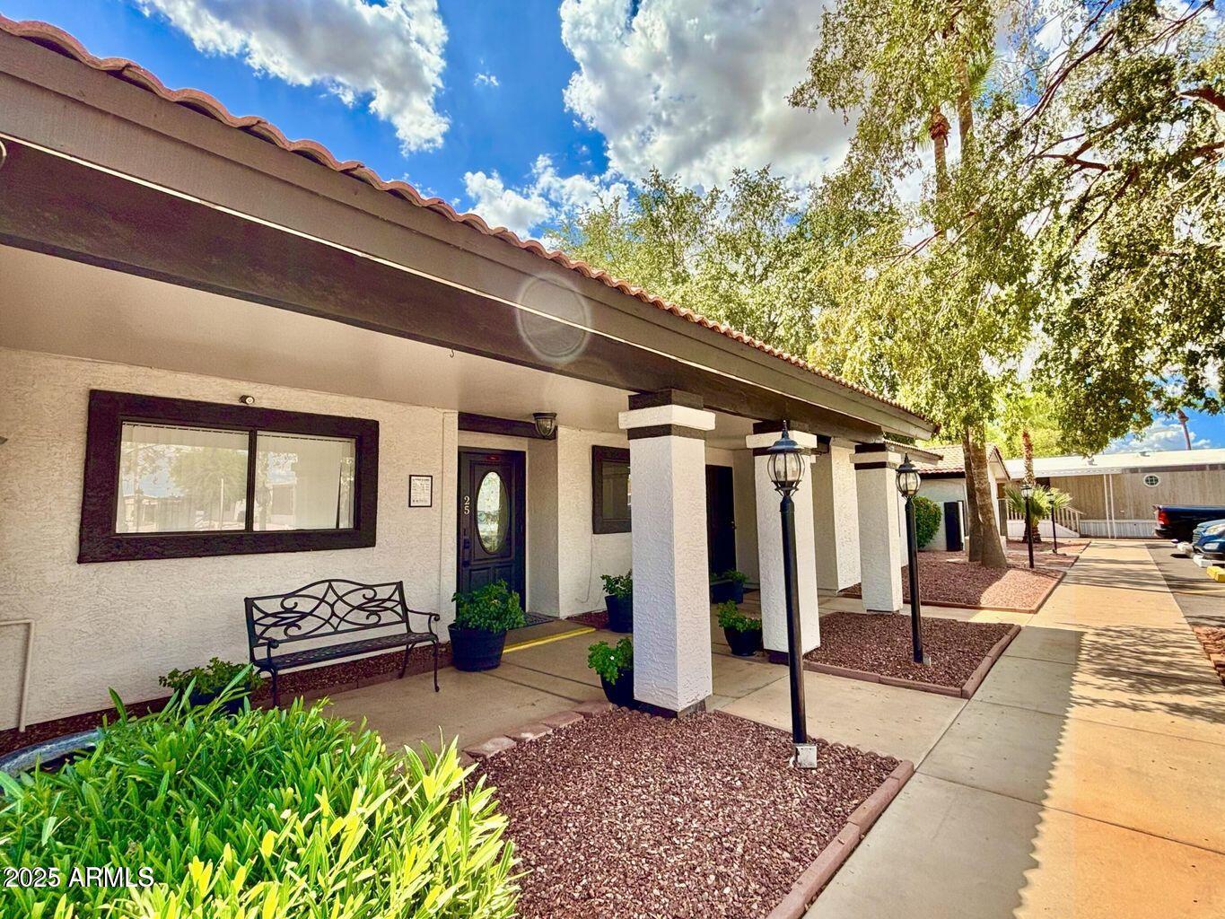 12721 West Greenway Road, Unit 114 El Mirage, AZ 85335 - Photo 7 of 10 a view of a house with a patio