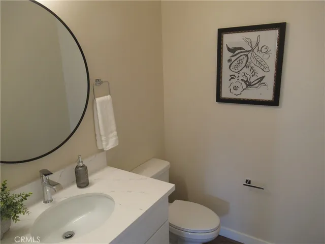 a bathroom with a sink mirror and toilet