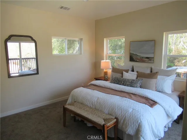 a bedroom with a bed and glass window