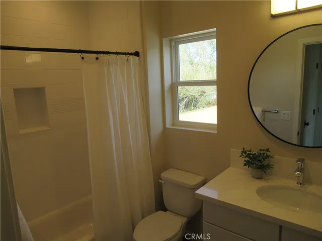 a bathroom with a sink toilet and a mirror
